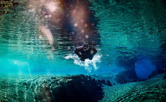 Silfra Snorkelling Tour: Float over lava and explore volcanic canyons—an adventure in Iceland's crystal-clear waters.