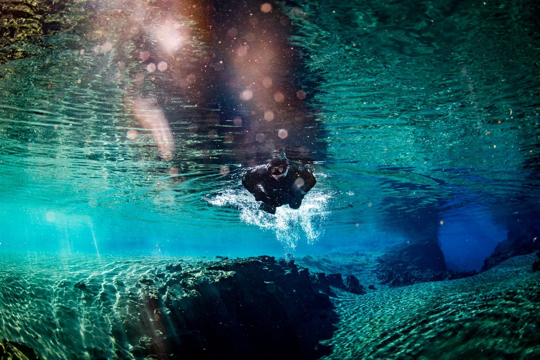 Silfra Snorkelling Tour: Float over lava and explore volcanic canyons—an adventure in Iceland's crystal-clear waters.